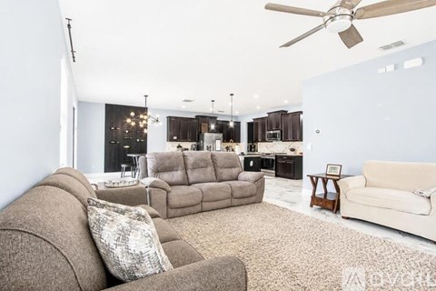 A living room with a brown couch and a white couch.