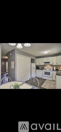 A modern kitchen with white cabinets and a large island.