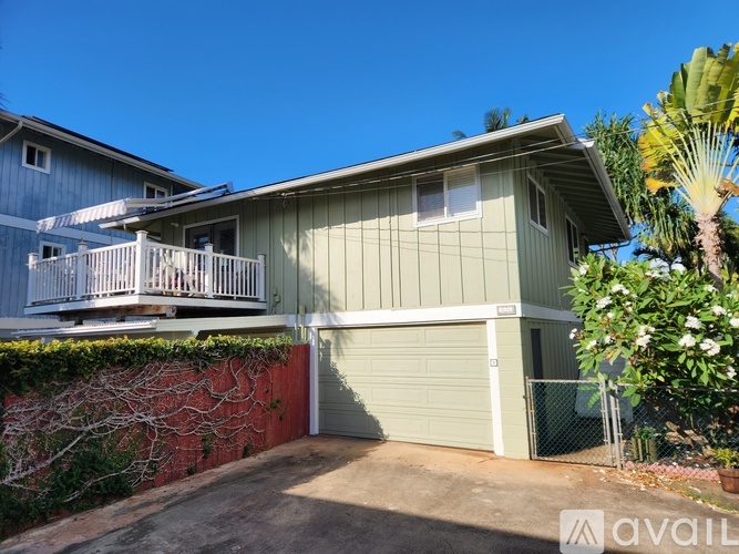 A house with a garage and a balcony is for sale.