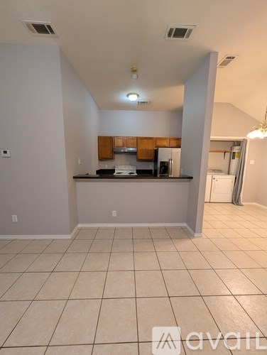 A kitchen area with a counter and cabinets.