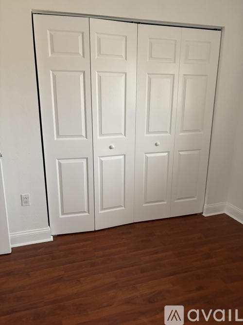 A white door with a panel design is closed.