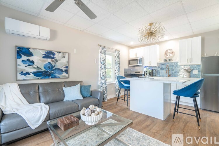 A modern living room with a grey sofa and a glass coffee table.