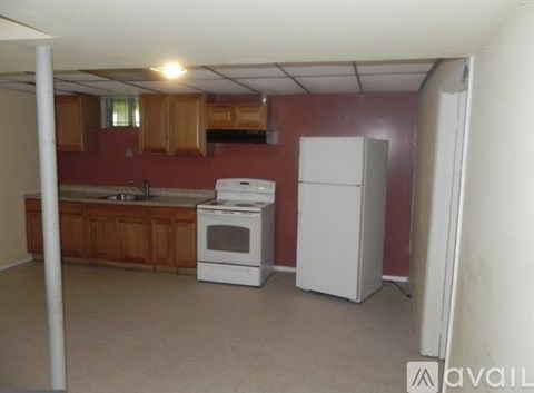A kitchen with a white fridge and oven.