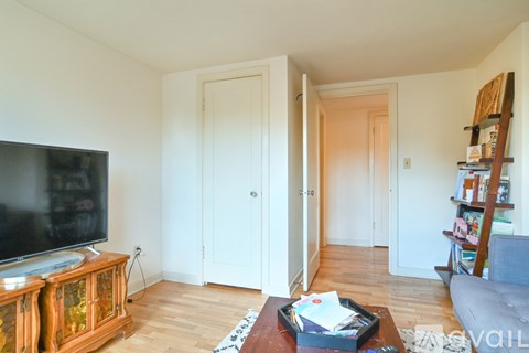 A living room with a television and a cabinet.