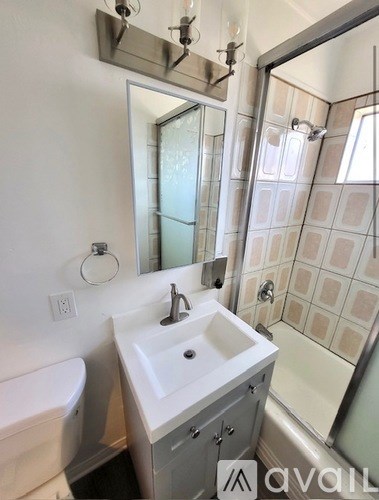A bathroom with a white sink and a white bathtub.