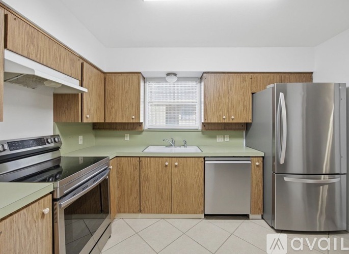 A kitchen with wooden cabinets and stainless steel appliances.
