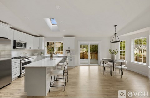 A modern kitchen with white cabinets and a large island.
