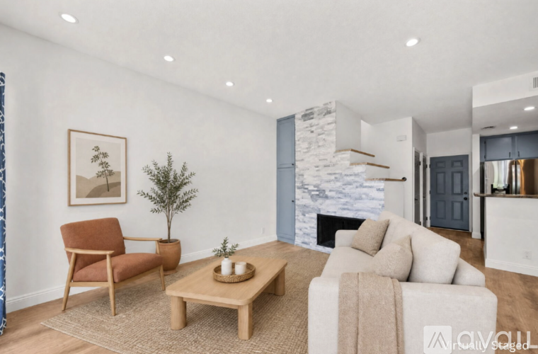 A living room with a fireplace and a chair.