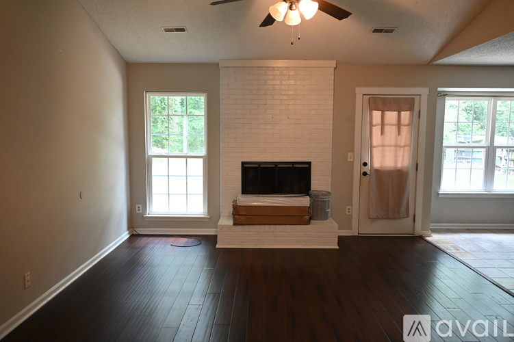 A living room with a fireplace and a flat screen TV.