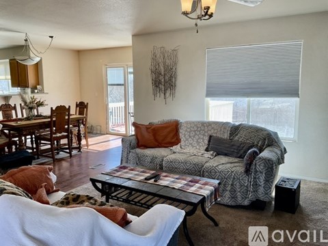 A living room with a grey couch and a coffee table.
