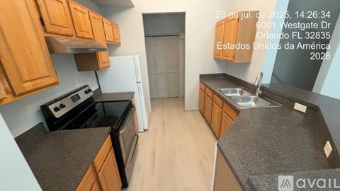 A kitchen with wooden cabinets and a black countertop is available for rent.
