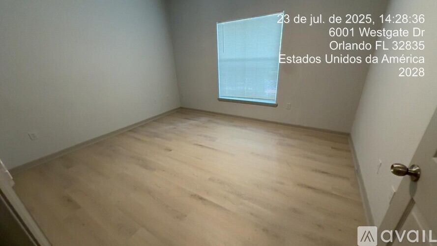 Empty room with wooden floor and a window on the wall.
