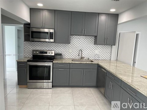 A kitchen with a stove top oven and microwave above it.