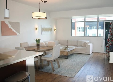 A modern living room with a dining table and chairs.