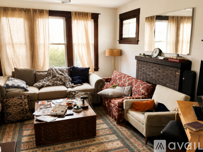 A living room with a couch, coffee table, and fireplace.