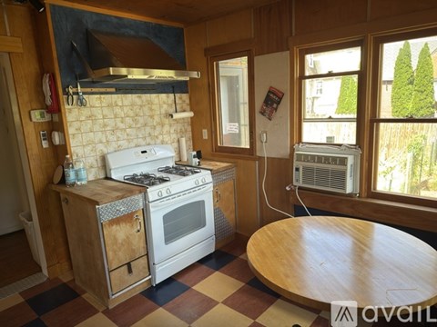 A kitchen with a stove and a table.