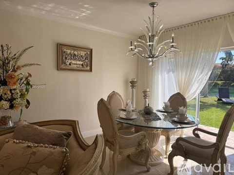 A dining room with a glass table and chairs.