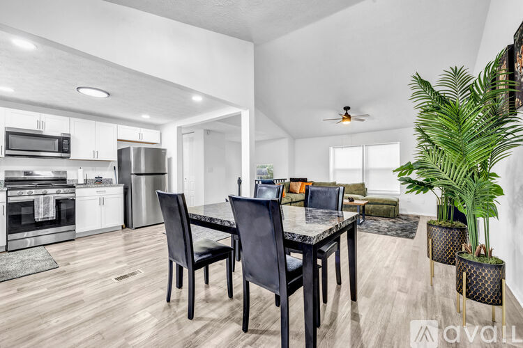 A modern kitchen with a dining table and chairs.