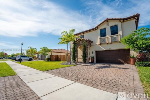 A house with a driveway and a car parked in front.