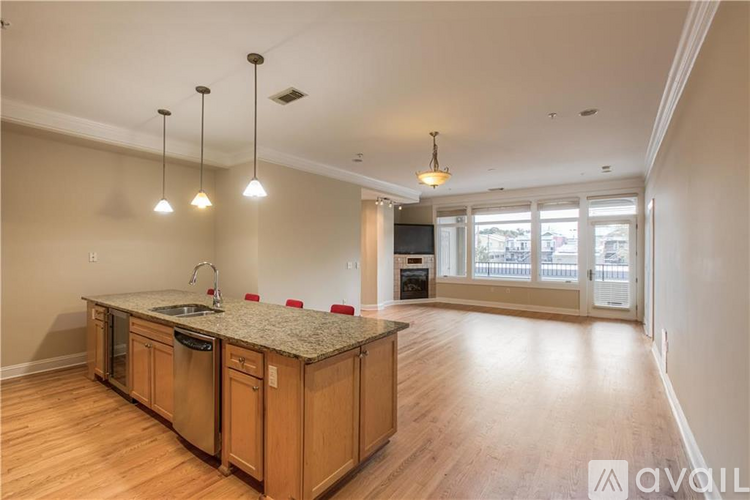 A kitchen with wooden cabinets and a granite countertop is available.