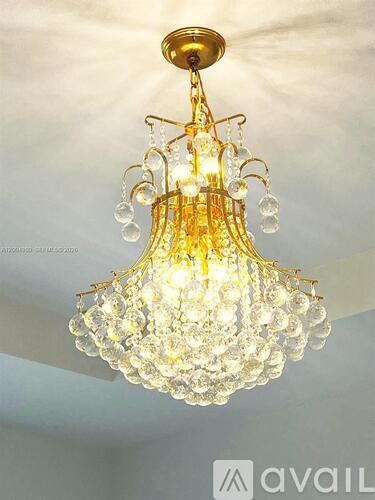 A chandelier with multiple tiers of glass globes hanging from a brass fixture.