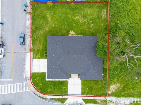 A red outlined area with a building in the middle.