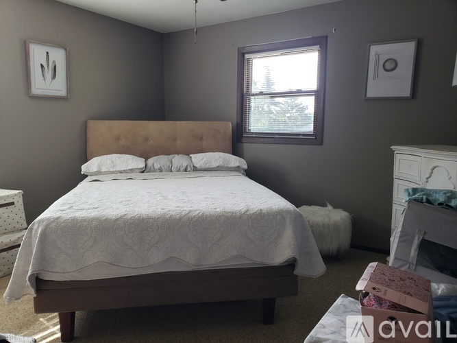 A bedroom with a large bed and a fireplace.