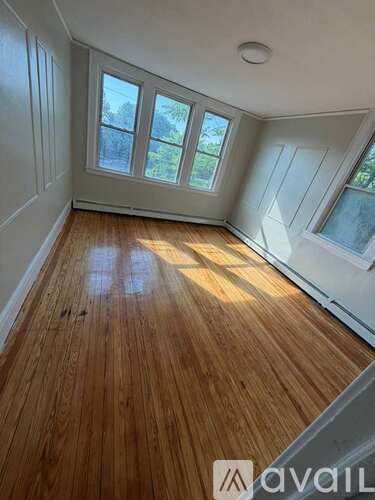 A room with wooden flooring and a skylight.