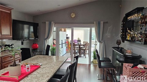 A kitchen with a dining table and chairs.