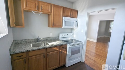 A kitchen with wooden cabinets and a granite countertop.