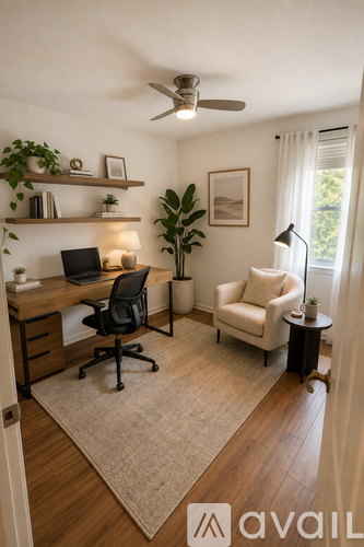 A room with a desk, chair, and shelves with plants.