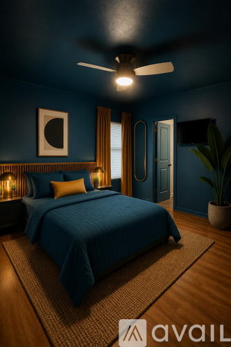 A bedroom with a bed, a ceiling fan, and a plant.