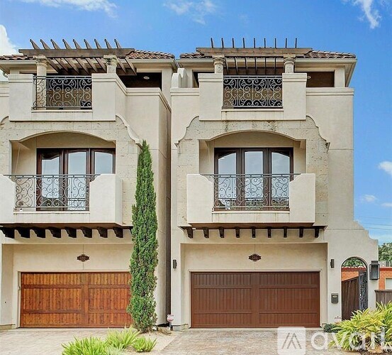 A two-story house with a balcony on the second floor.