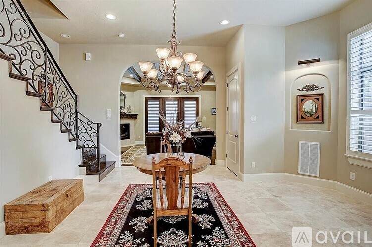 A dining room with a wooden table and chairs.