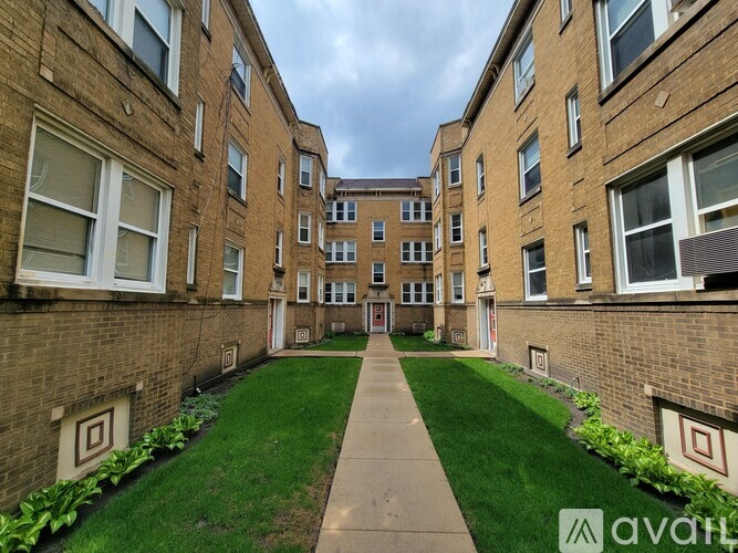 A long hallway with a green lawn on either side.