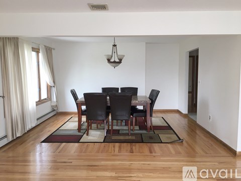 A dining room with a table set for four.