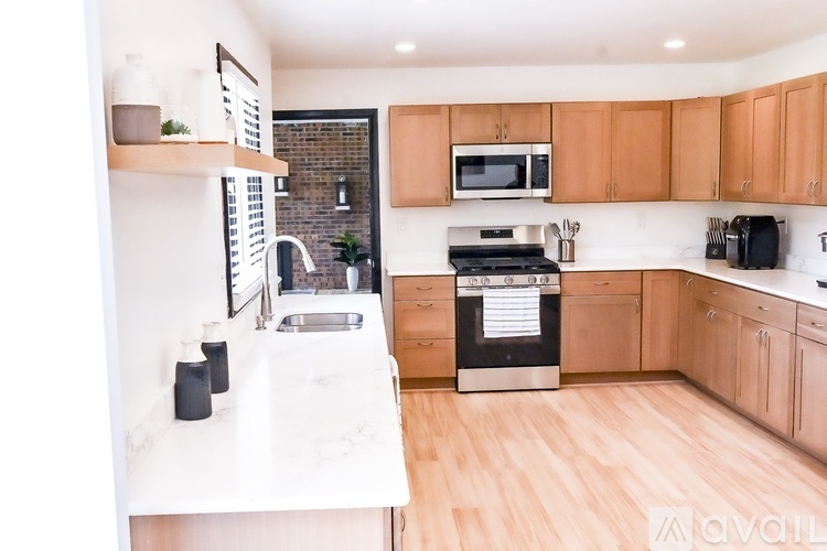 A kitchen with wooden cabinets and a black oven.