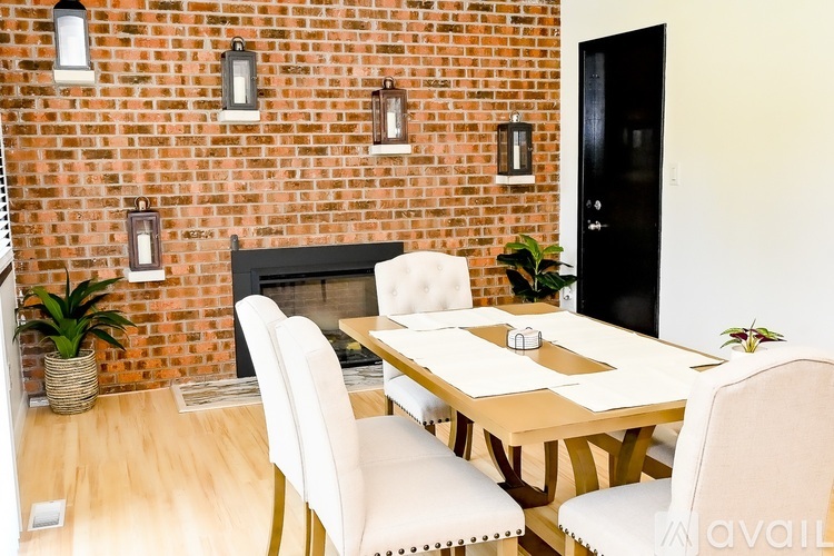 A dining room with a wooden table and chairs.