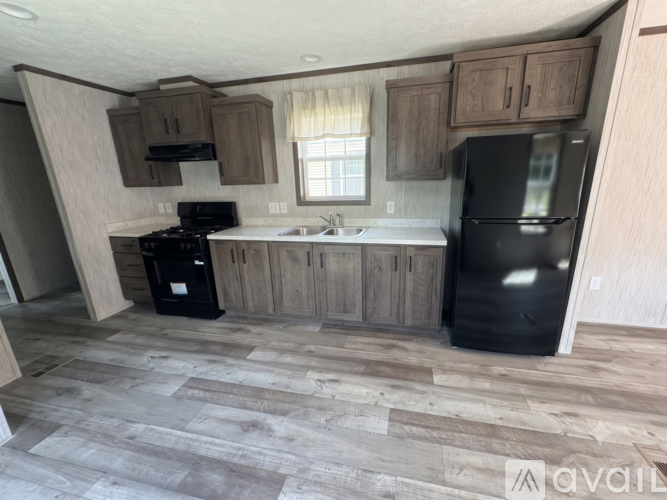 A kitchen with a black fridge and a black stove.