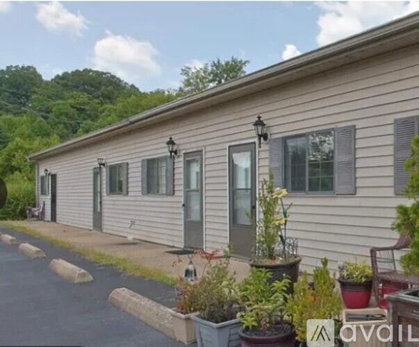 A row of houses with a sign that says "AVAILABLE" in front of the first one.