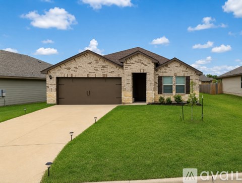 A house with a garage and a driveway in front.
