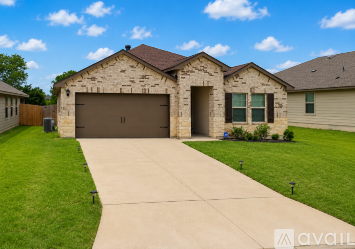 A house with a garage and a driveway in front.