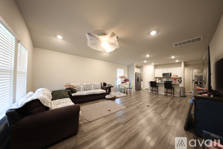 A living room with a brown couch and a white sofa.