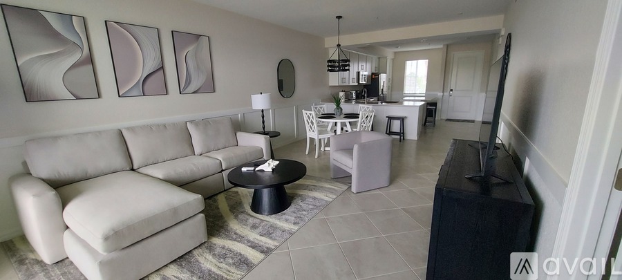 A living room with a grey sofa and a black coffee table.