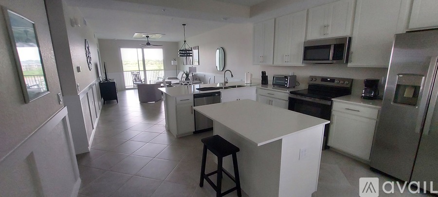 A kitchen with white cabinets and appliances.