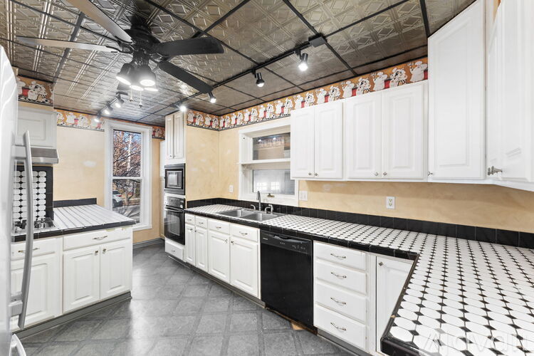 A kitchen with black and white checkered floor.