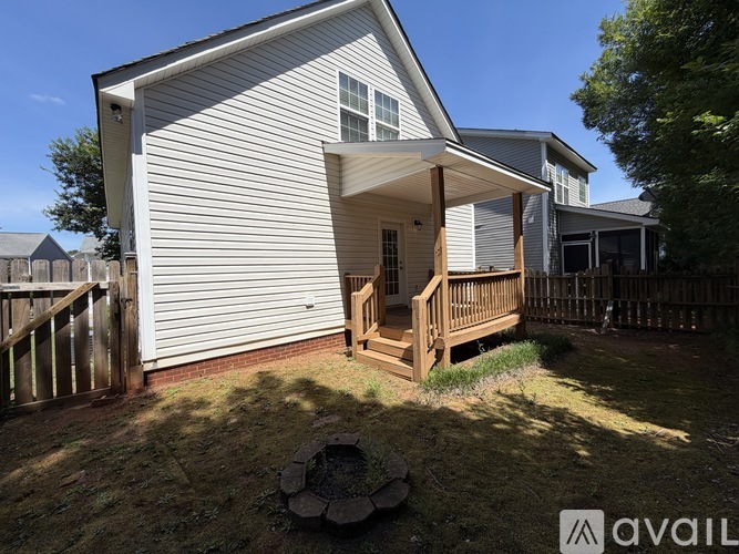 A house with a white exterior and a wooden deck.