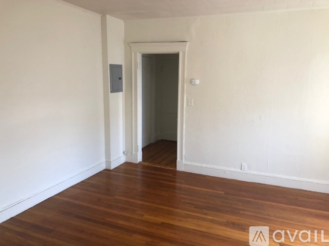 A room with wooden floors and a white door.