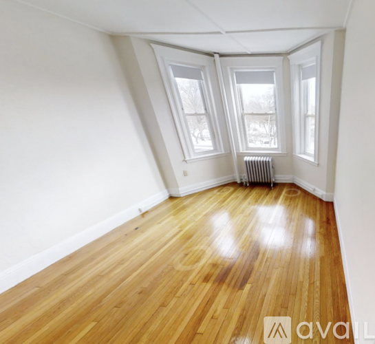 A room with wooden floors and white walls.