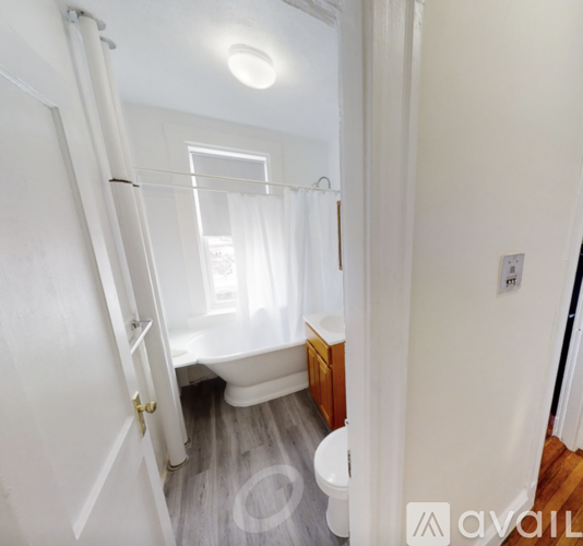 A bathroom with a toilet, sink, and bathtub is available for rent.